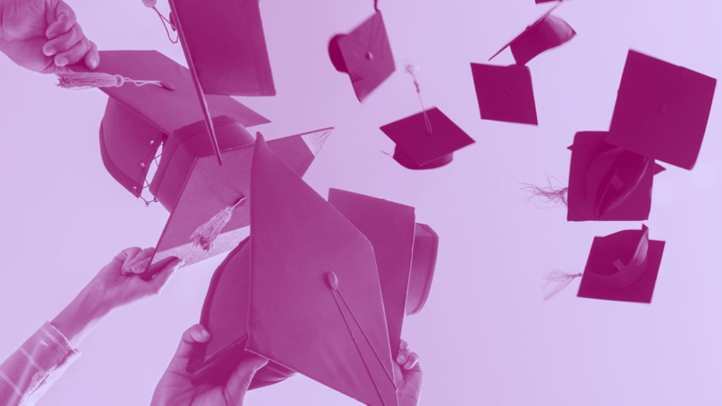 graduation caps thrown into the air, purple filter.