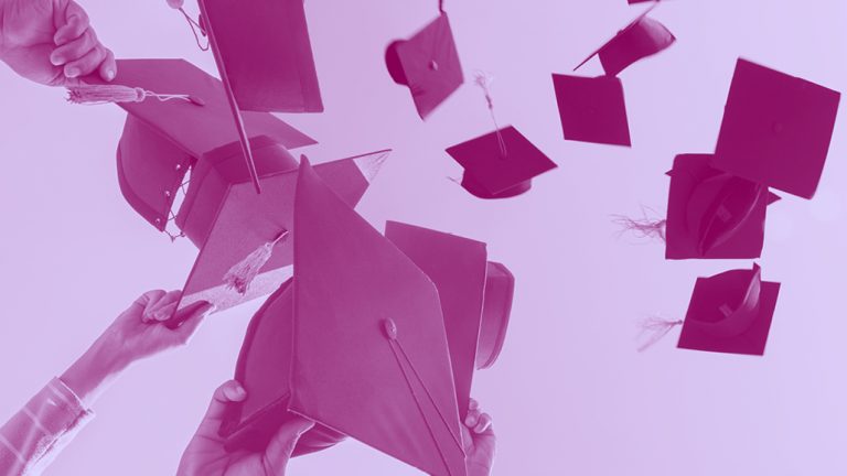 graduation caps thrown into the air, purple filter.