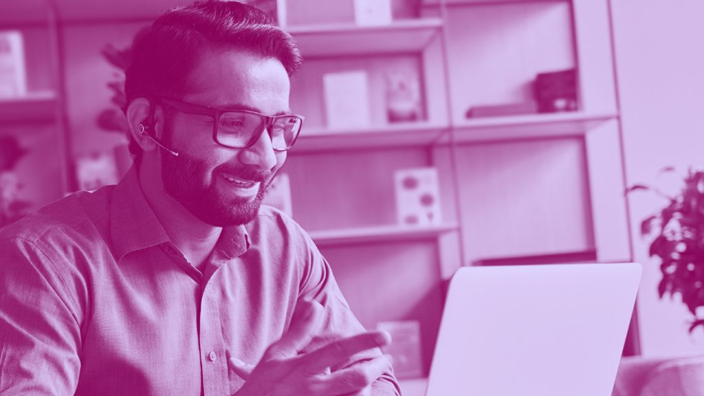 man working on a laptop, in purple filter.