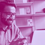 man working on a laptop, in purple filter.