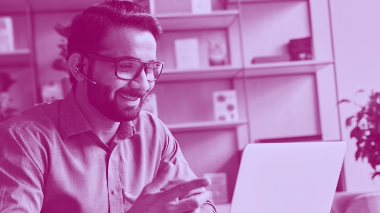 man working on a laptop, in purple filter.