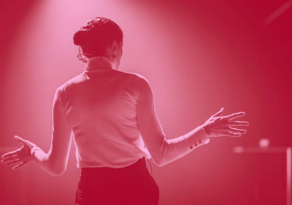 back view of a woman on stage, red filter