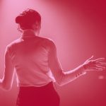 back view of a woman on stage, red filter