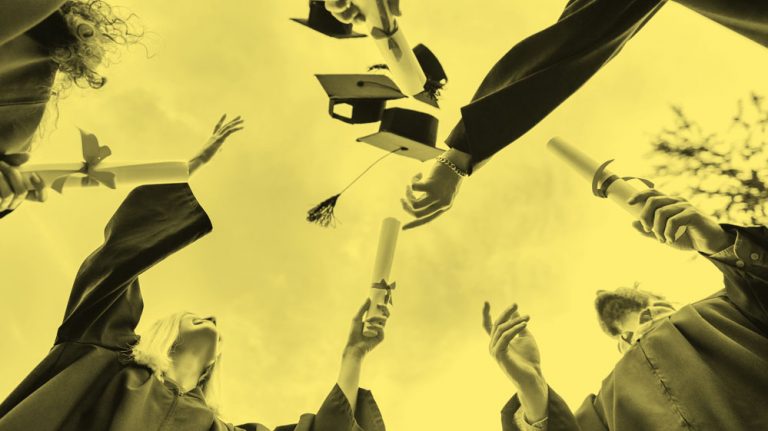upward view of graduates tossing their caps into the air, yellow filter.
