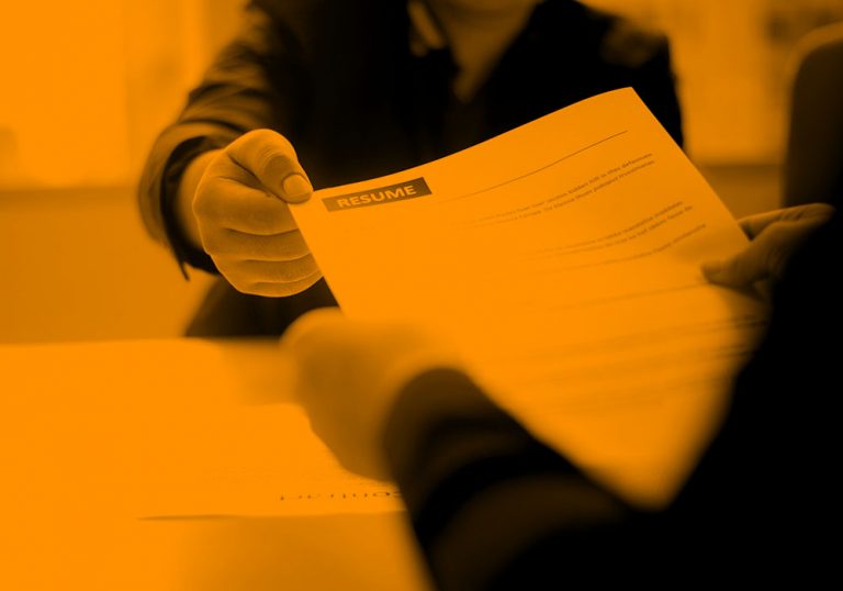 Image of someone handing over their resume, in an orange filter.