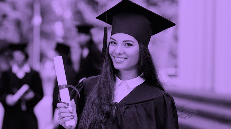 image of woman holding up diploma at graduation