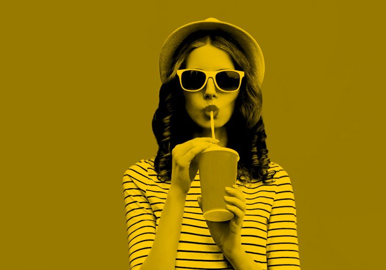 woman listening to music and enjoying a drink