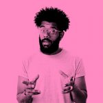 man in t-shirt and glasses gesturing