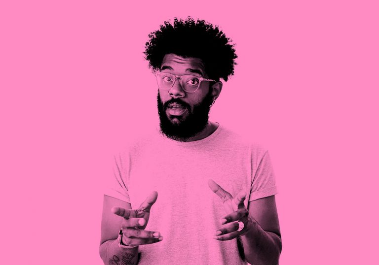 man in t-shirt and glasses gesturing