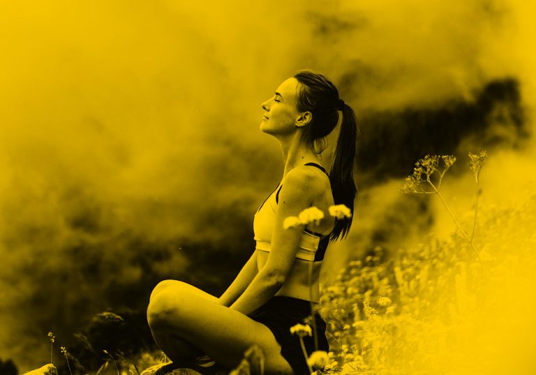woman meditating in field