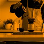 person pouring hot water into a coffee maker