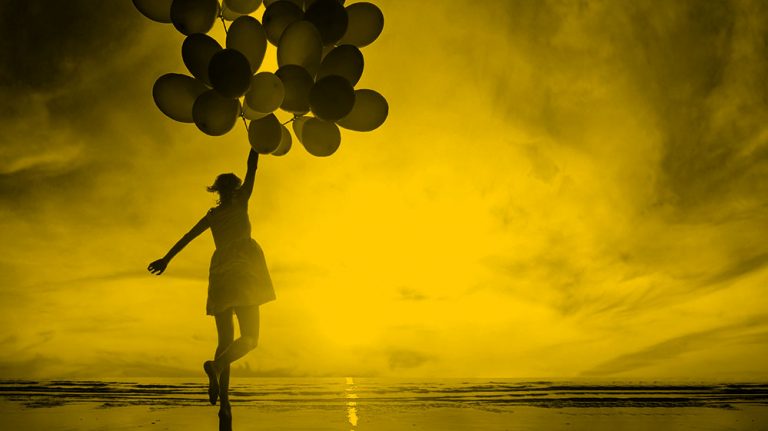 woman holding balloons
