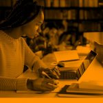 woman working on computer in library