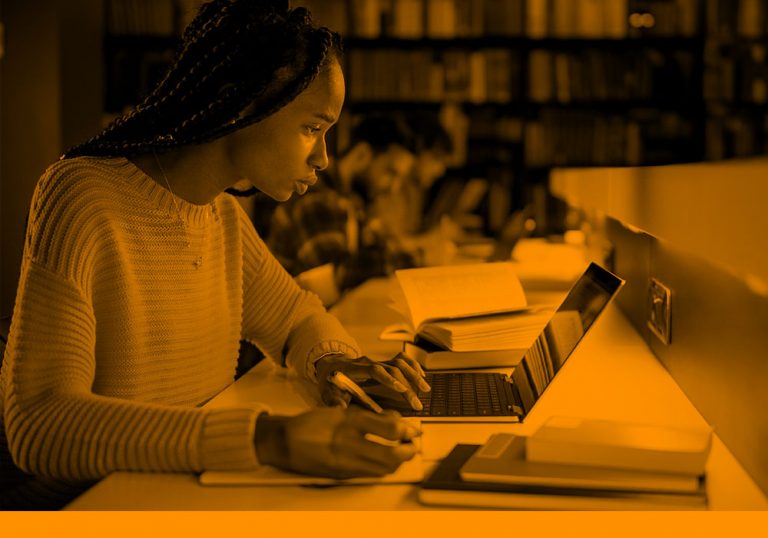 woman working on computer in library