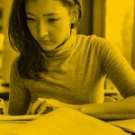 woman writing and researching, yellow filter