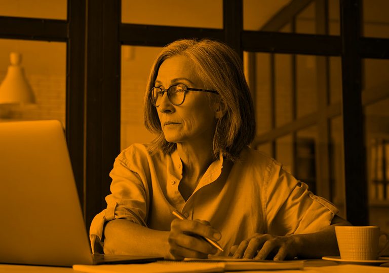 woman working in office; orange filter