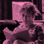 woman reading book; pink filter