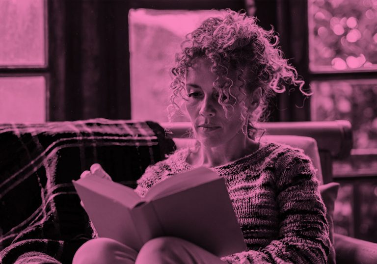 woman reading book; pink filter