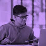 male student working on laptop, purple filter