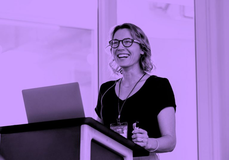 woman giving presentation, purple filter