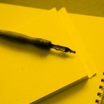 notepad and pen; yellow filter