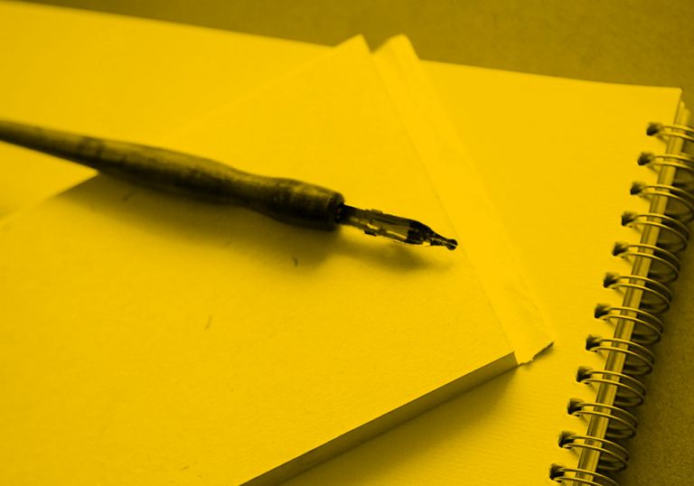 notepad and pen; yellow filter