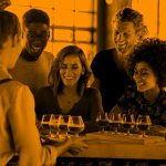 group of friends at bar; orange filter