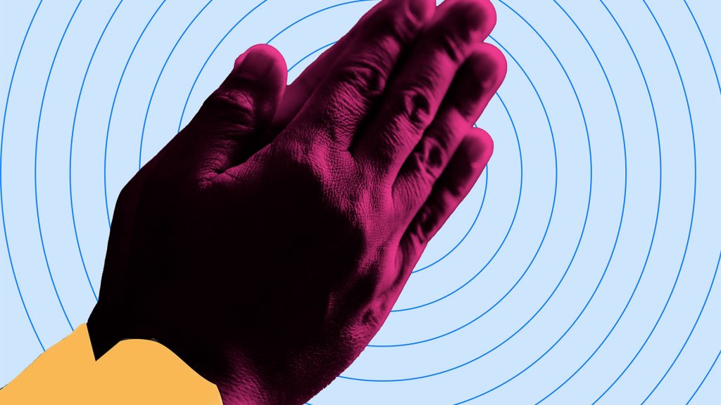 two purple hands clasped together on blue bullseye background